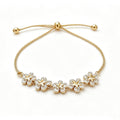 Gold-plated bracelet with five rhinestone flowers and a sliding bead closure