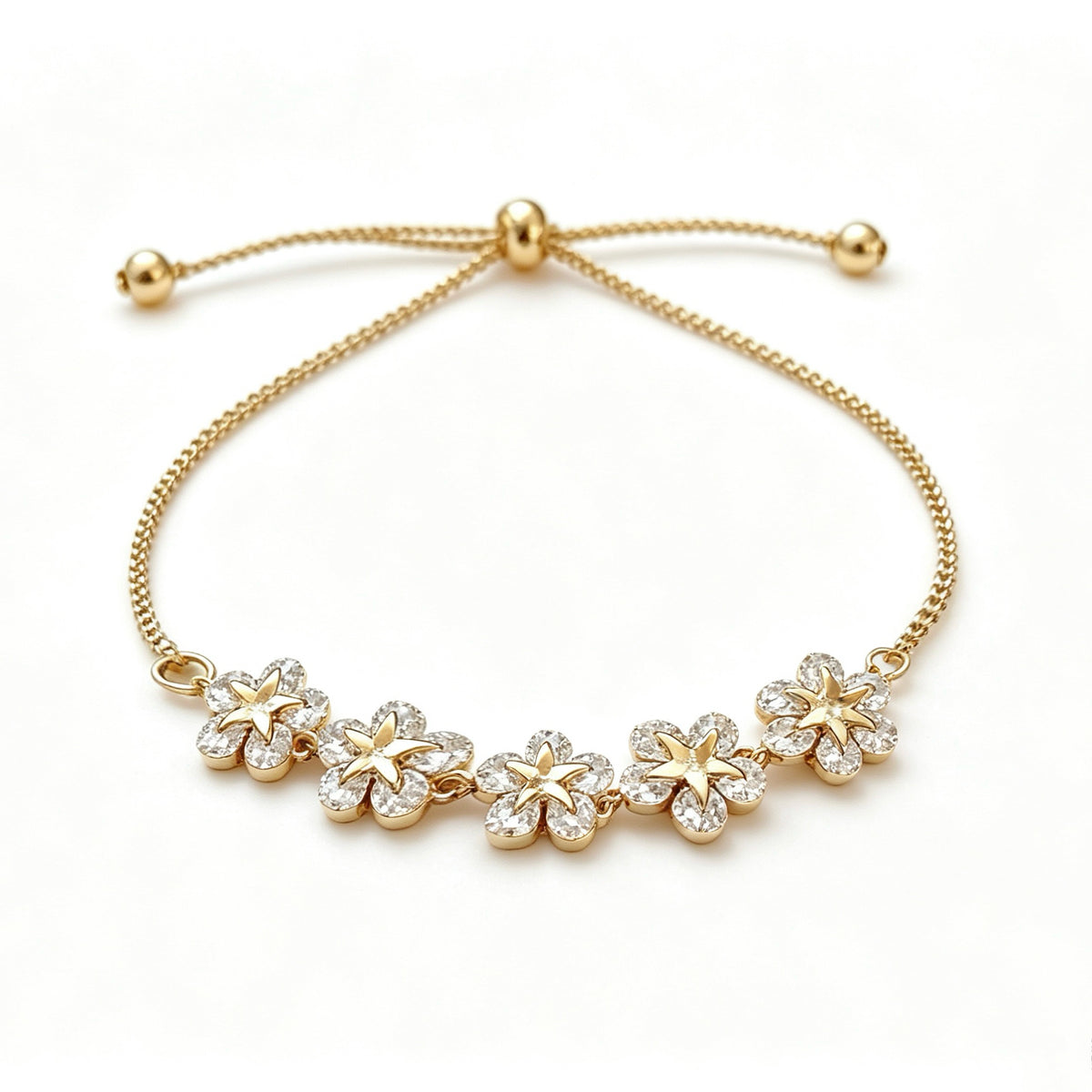 Gold-plated bracelet with five rhinestone flowers and a sliding bead closure