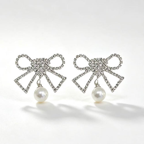 Crystal rhinestone bow earrings with pearl drop pendant in silver tone
