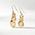 Gold hammered cascading disc drop earrings with silver hook and crystal accent