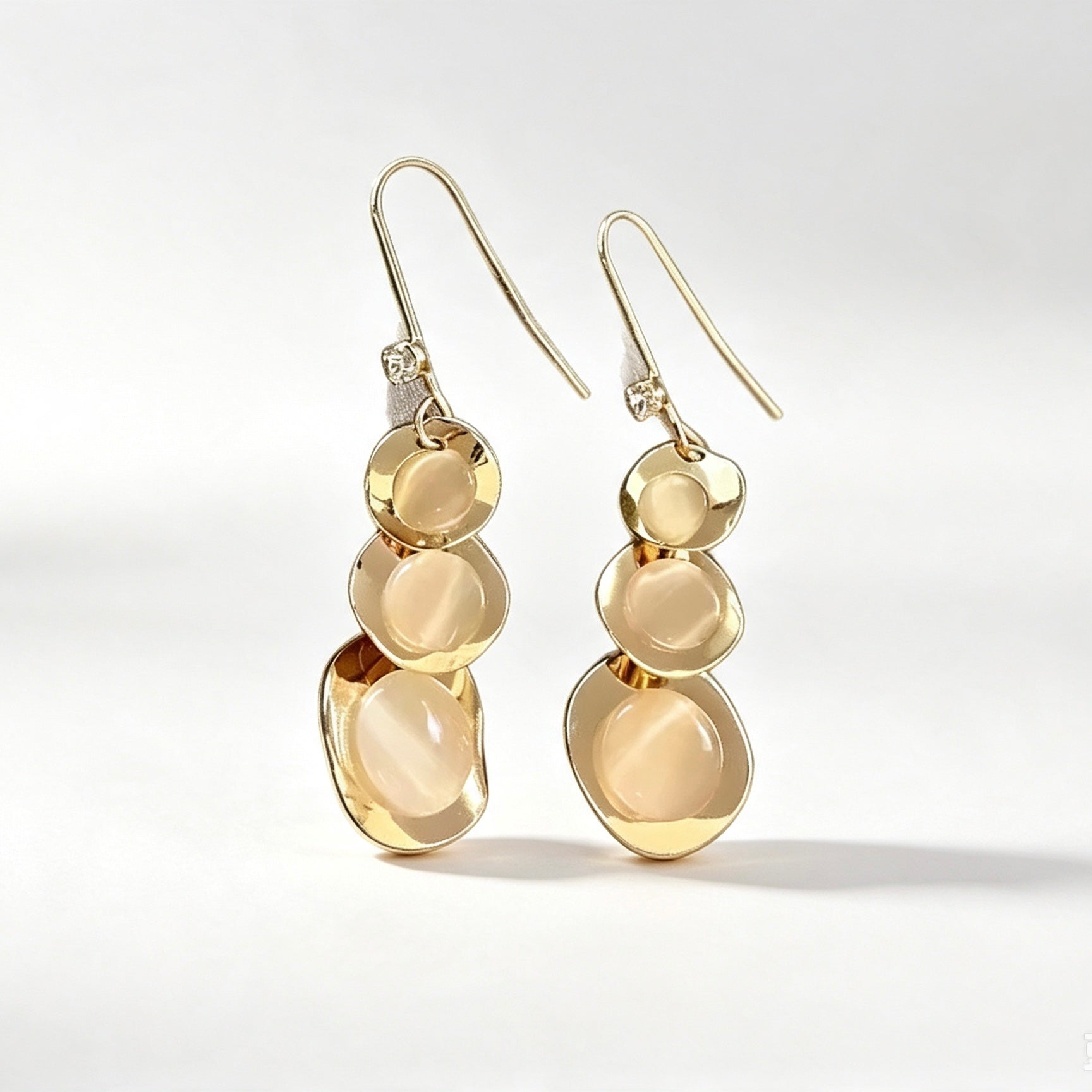Gold hammered cascading disc drop earrings with silver hook and crystal accent