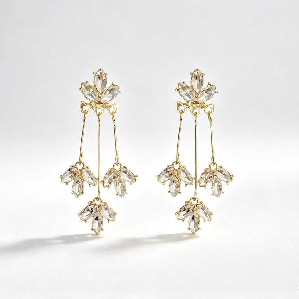 Gold tone crystal marquise tassel drop earrings with triple strand and cluster drops