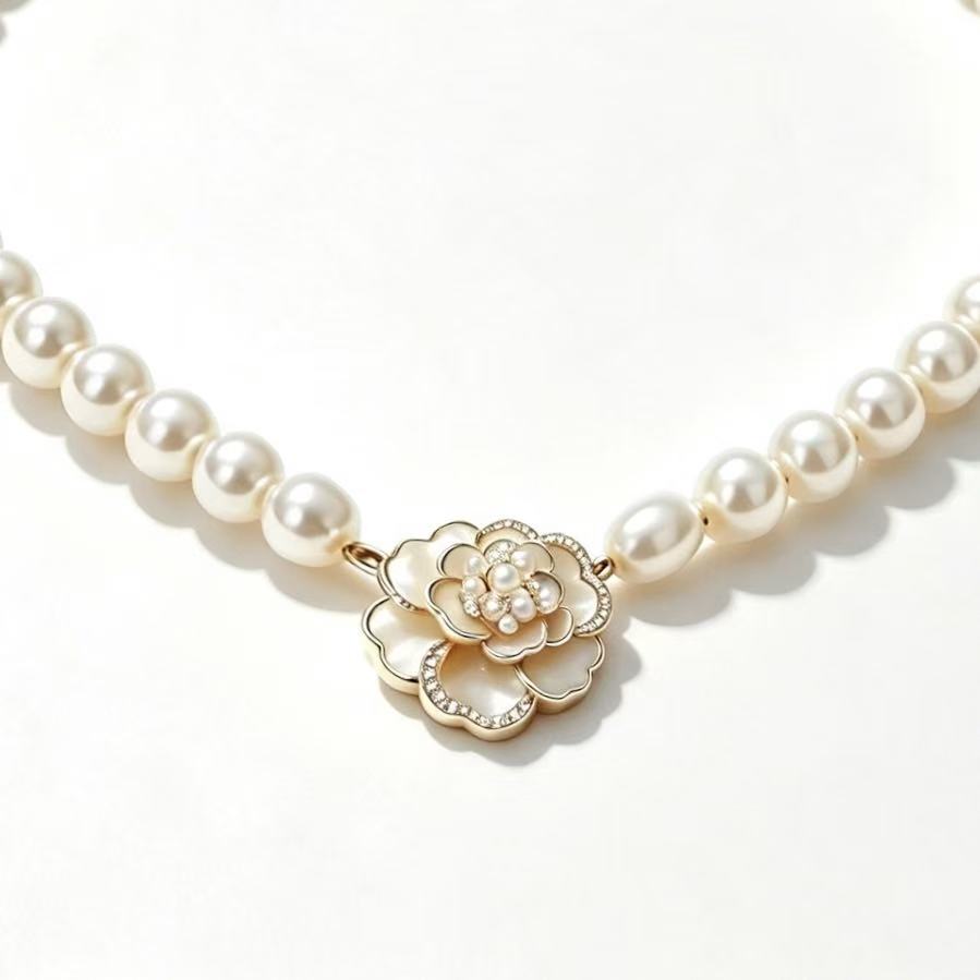 Pearl Strand Camellia Necklace - round pearl strand with white enamel camellia flower center and seed pearl cluster in gold-tone setting