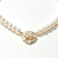 Pearl Strand Camellia Necklace - round pearl strand with white enamel camellia flower center and seed pearl cluster in gold-tone setting