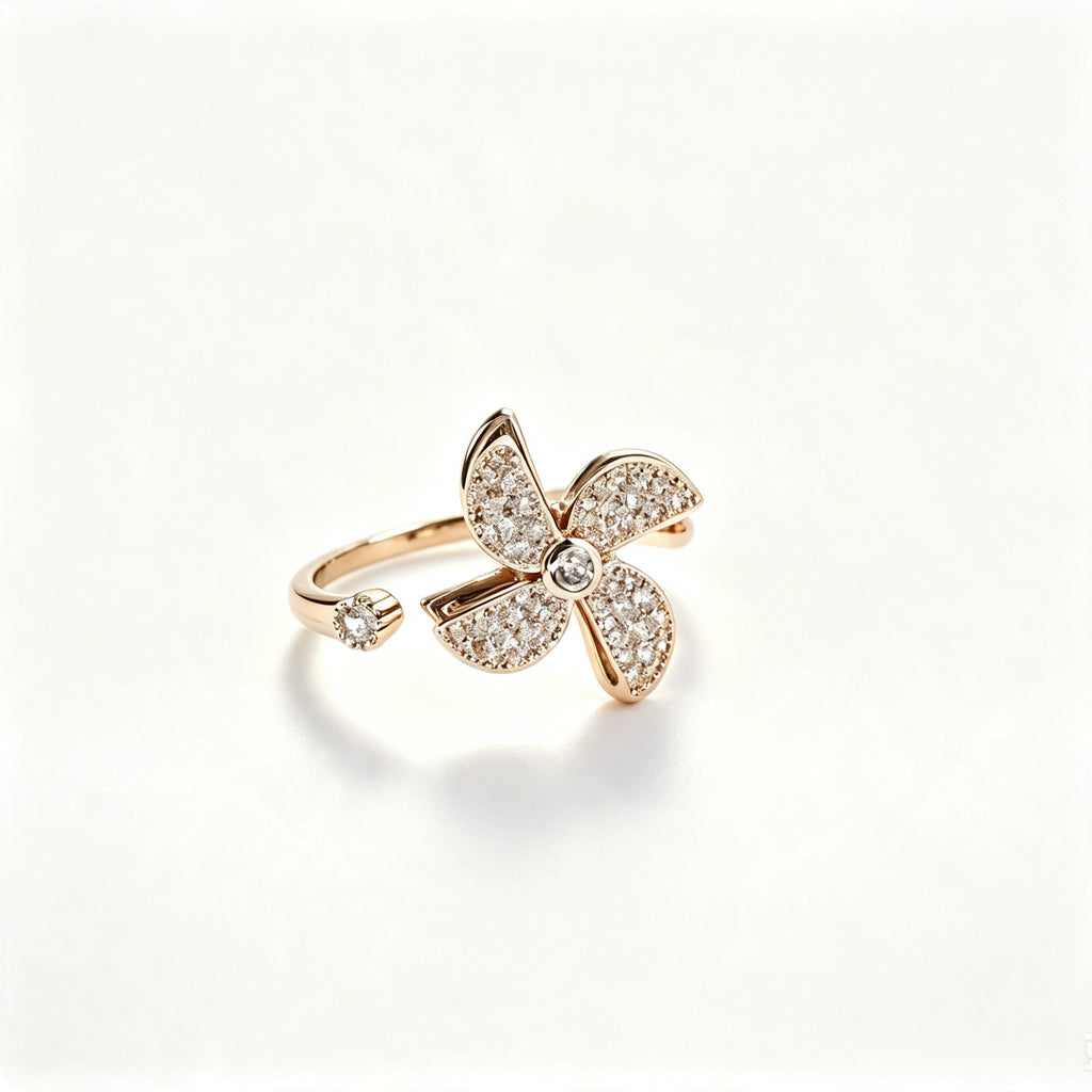 Rose gold open-band ring with fully pavé crystal four-petal flower and solitaire crystal tip