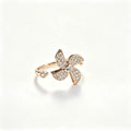 Rose gold open-band ring with fully pavé crystal four-petal flower and solitaire crystal tip