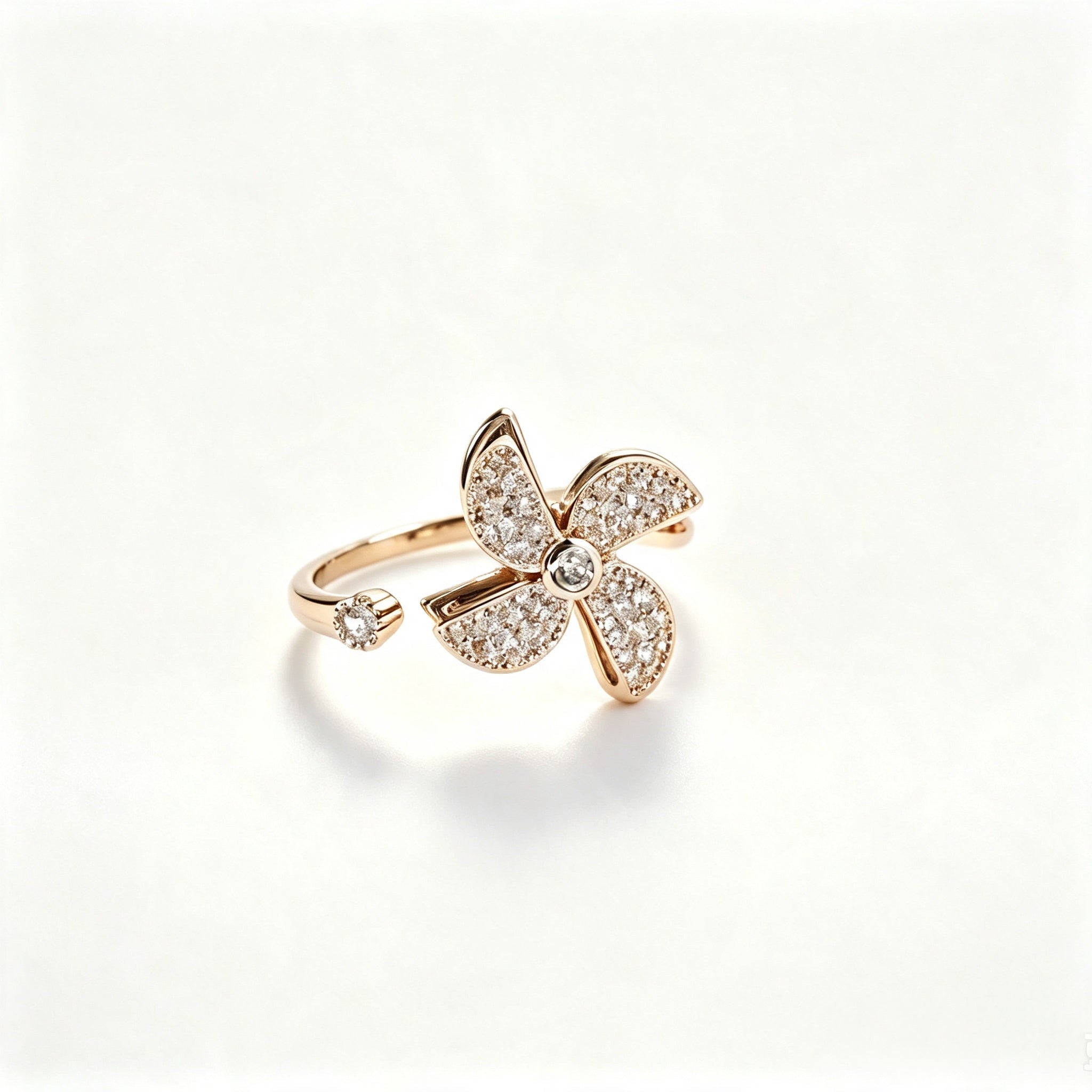 Rose gold open-band ring with fully pavé crystal four-petal flower and solitaire crystal tip
