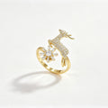 Gold open-band ring with pavé crystal deer and baguette snowflake in 18K gold plating