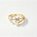Gold double-band ring with pearl accents and crystal star centerpiece